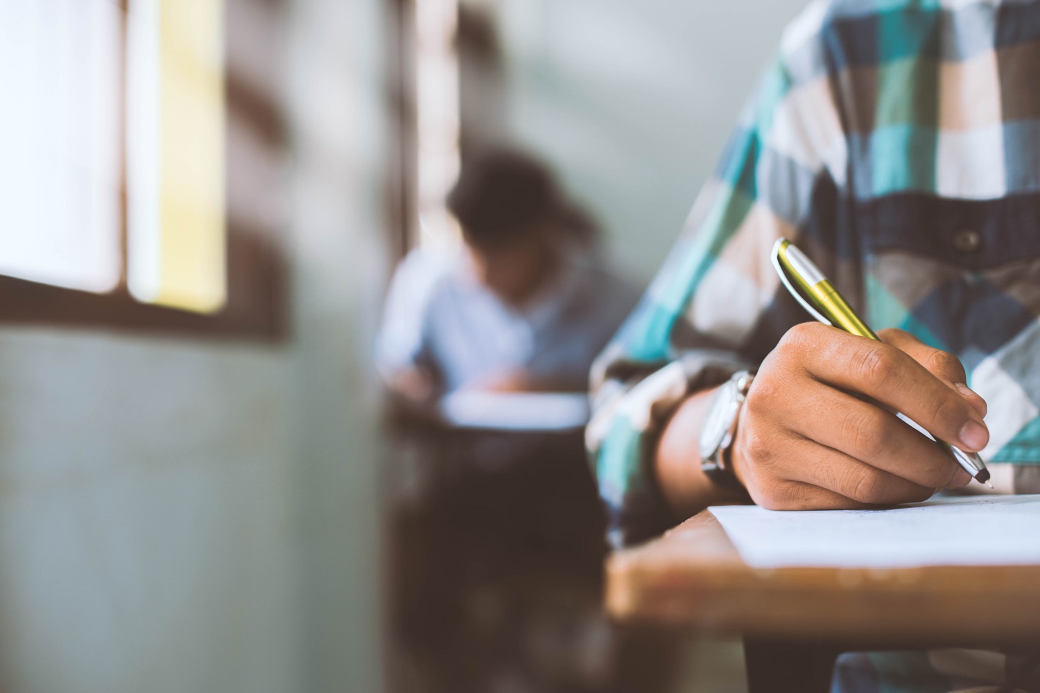 close-up-students-writing-reading-exam-answer-sheets-exercises-classroom-school-with-stress